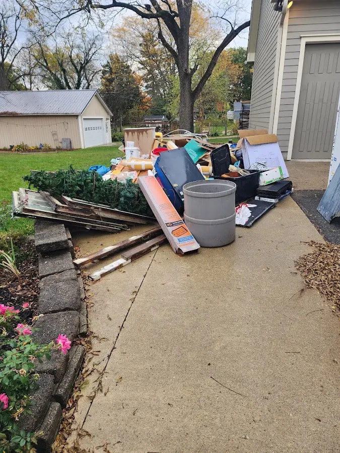 Dumpster being loaded with debris for 12 Yard Dumpster Rental in Nether Providence